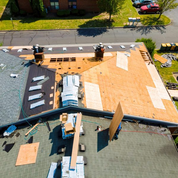 While repairing roof apartment building, old shingles replaced plywood and new shingles were